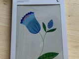 a picture of a picture of a blue flower in a box