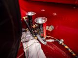 a can of soda sitting on the back of a red truck