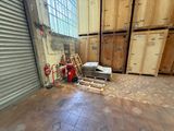 a room with a lot of wooden crates and a red fire hydrant