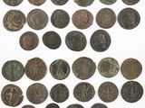 a group of old coins sitting on top of a white surface