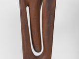 sculpture made of wood with a curved design on a white background