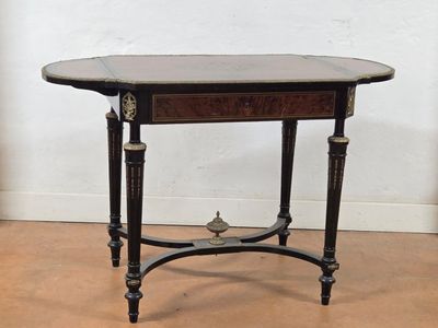 a small table with a black top on a wooden floor