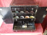 a small chest of drawers with a lot of items in it