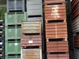 many stacks of wooden crates stacked on top of each other