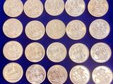 a pile of silver coins sitting on top of a blue surface