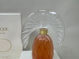 a bottle of perfume sitting on a table next to a box