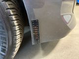 a close up of a car tire with a sticker on it