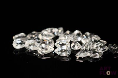 a close up of a bunch of diamonds on a black surface