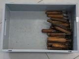 a box full of wooden baseball bats sitting on the floor