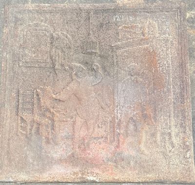 a stone plaque on the side of a building that has a picture of a man riding a horse
