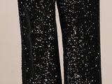 pantalon noir à paillettes avec des fermetures éclair sur les côtés
