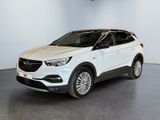 a white car is parked in a white room with a black floor