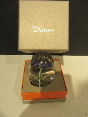 a glass vase with a flower in it sitting in a box