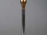 silver and gold candle holder on a silver surface