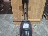 an image of a red and black floor scruber