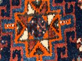 an orange, blue, and red rug with a design on it