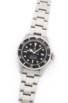 a close up of a watch on a white surface with a white background