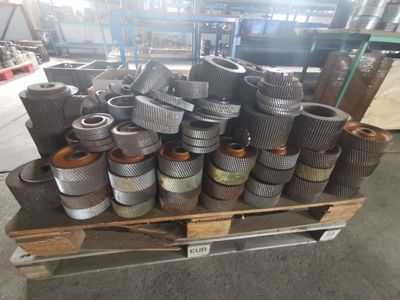 a large pile of metal pipes sitting on top of a pallet