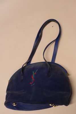 blue leather purse with red and green embroidery on it