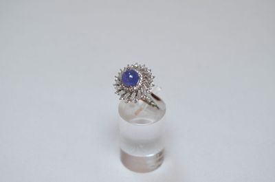 an image of a blue sapphire and diamond ring on a white surface