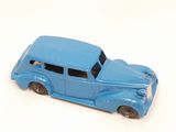 a blue toy car that is sitting on a white surface