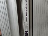 a toilet that has a sign on the side of it