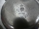 a silver pot sitting on top of a table
