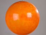 an orange glass ball hanging from a metal rod