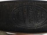 a person holding a pair of black shoes in their hand