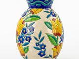 a blue vase with yellow and blue flowers on it