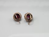 a pair of gold and garnet stone earrings