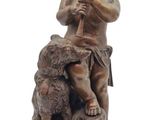 bronze statue of a boy with a dog on a marble base
