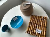 a small table with a bowl and a cup on it
