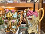 many vases that are on display in a glass case