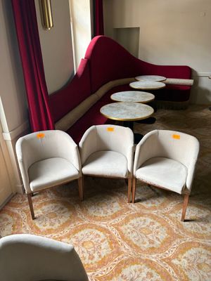 four chairs and a table in the corner of a room