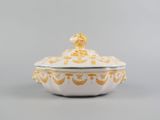 a white and gold tureeny dish with a lid