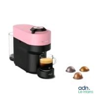 an image of a pink and black coffee maker next to a cup of coffee