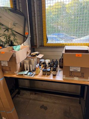 a desk with a lot of boxes and bottles on it