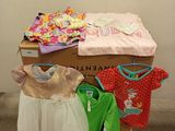 many baby clothes on display in a room