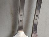 two spoons that are sitting next to each other on a table
