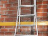 a ladder leaning against a brick wall in a warehouse