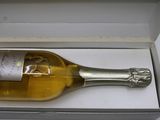 a bottle of wine in a box on a table