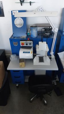 a desk with a computer and a printer on it in a room