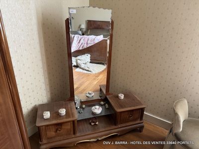 an image of a bedroom with a dresser and a mirror