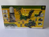 a box of legos with a tractor and other construction toys