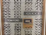 many pairs of glasses on display in a display case