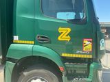 a green truck with a yellow z logo on the side of it