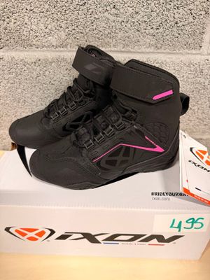 a box with a pair of black and pink shoes on it