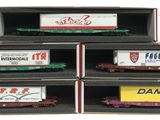 three train cars in a box on display in a display case