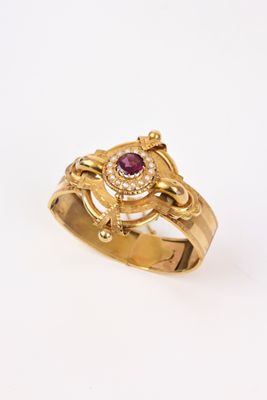 une image représentant une bague en or ornée d'un rubis au centre